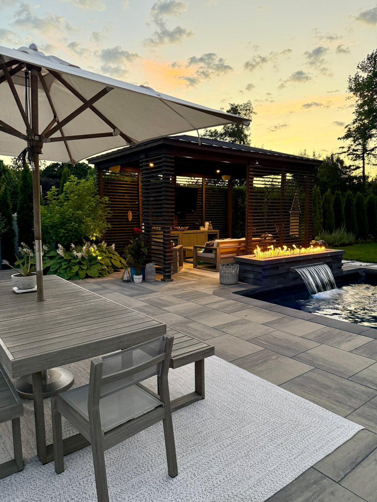 Luxury outdoor living space with pool and fire pit