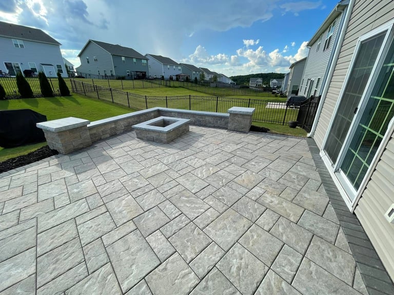 Backyard patio with fire pit and seating area in residential neighborhood